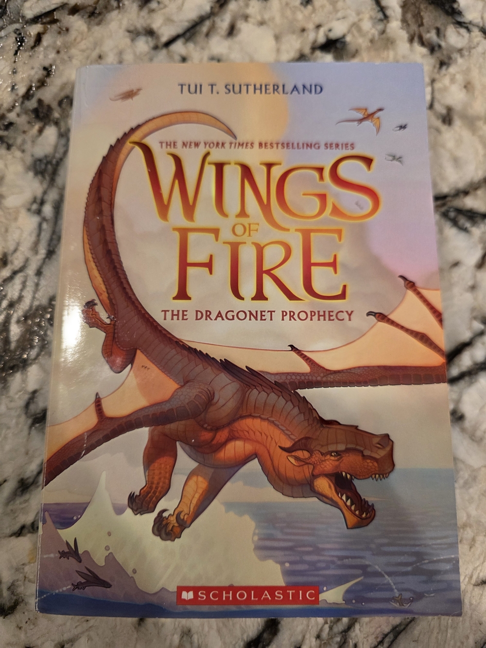 Scholastic Wings of Fire paperback with orange dragon artwork